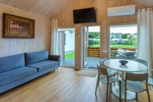 a living room with a couch and a table at Namelis Genio 7 in Palanga