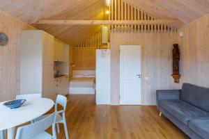 a living room with a couch and a table at Namelis Genio 7 in Palanga