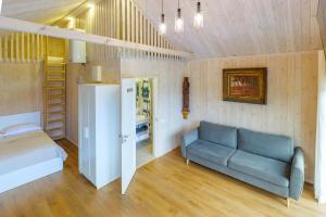 a living room with a couch and a bed at Namelis Genio 7 in Palanga