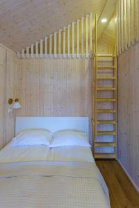 a bedroom with a bed with a ladder in it at Namelis Genio 7 in Palanga +5 photos