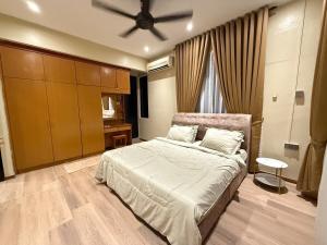 a bedroom with a bed and a ceiling fan at White House - Alor Setar in Alor Setar