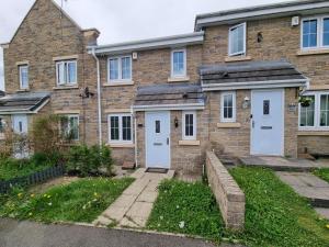 a brick house with white doors and windows at Leyland Road Retreat - 4 Bedroom House in Burnley