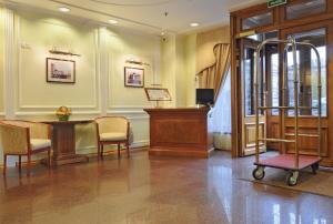 a lobby with a desk and chairs and a podium at Dostoevsky Hotel in Saint Petersburg