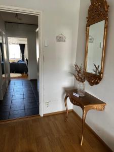 a room with a table and a mirror on the wall at Lemmenpesä Ytimessä in Oulu