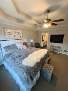 a bedroom with a large bed and a ceiling fan at The Plush Retreat Marietta With Soaker Tub Walk In Closet in Marietta