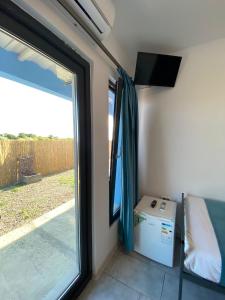 a room with a sliding glass door and a window at Sea Side in Vama Veche