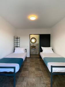 two beds sitting next to each other in a room at Sea Side in Vama Veche