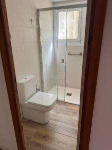a bathroom with a toilet and a glass shower at Villa Escorpion Tossa de Mar in Tossa de Mar +40 photos