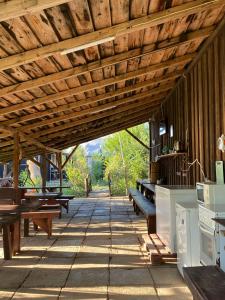 a patio with benches and a wooden ceiling at La Valentina si Gabriel in Vadu