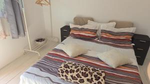 a bed with two pillows on it in a room at La Valentina si Gabriel in Vadu +23 photos