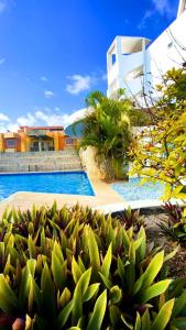 a view of a swimming pool and a house at Hotel Aventura Suites Tucacas in Tucacas