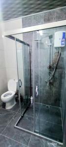 a bathroom with a toilet and a glass shower at Likya Vadi Evleri Nature and tranquility in Antalya +12 photos