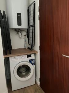 a washing machine in a small room with a door at Heart of Tréguier Ideal for 2 people in Tréguier