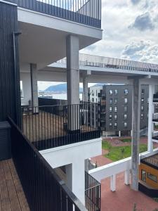 a balcony of a building with a view of the ocean at Oceanfront Stay, Large Balcony and Rooftop Access in Bergen