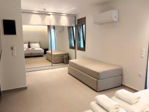a bedroom with a bed and a mirror at Luminous Luxury Apartments in Limenas +109 photos