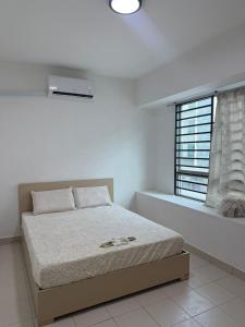 a white bedroom with a bed and a window at AH Comfy Home in Gua Sai +4 photos