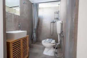 a bathroom with a toilet and a sink and a shower at Rethymno Dome Garden in Rethymno +98 photos