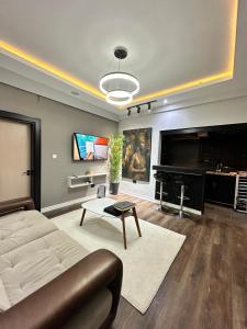 a living room with a couch and a flat screen tv at The Nook in Abuja