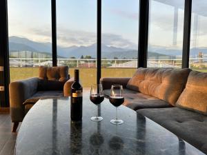 two glasses of wine on a table in a living room at Terrace Eniseli in Eniseli