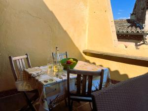 a table with a bowl of fruit on top at provencal house with sunny terrace in Aups