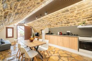 a kitchen and dining room with a table and chairs at Rethymno Dome Garden in Rethymno