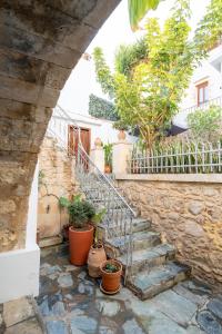 a stone stairway with potted plants on it at Rethymno Dome Garden in Rethymno
