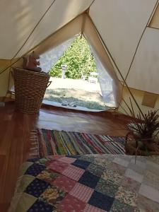 a view from inside a tent with a window at Tenda romantica nel Noccioleto in Castellero