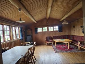 a dining room with a table and chairs in a building at Utsikten in Geilo