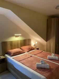 a bedroom with a bed with two pillows on it at Apartman LANA 2023 in Arandjelovac