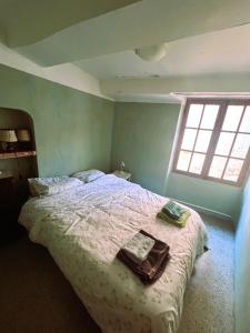 a bedroom with a bed with two towels on it at provencal house with sunny terrace in Aups
