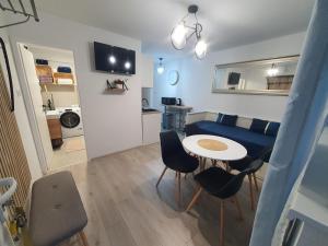 a small living room with a table and a couch at Apartman Jež 4 De Lux - self check in, free parking in Karlovac