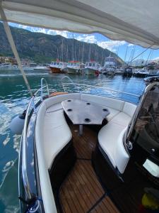 a boat with a table in the middle of the water at Boka Boat Tours in Kotor