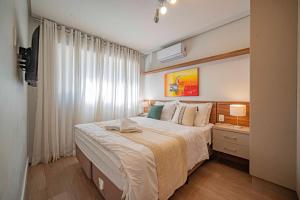 a bedroom with a large bed and a window at L'Adresse Réserve 150m R Coberta by Achei Gramado in Gramado +27 photos