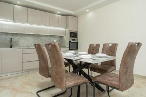a kitchen with a dining room table and chairs at Villa Tivat in Tivat