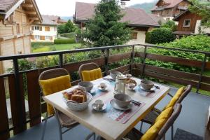 a table with a basket of food on a balcony at Apartment for 4 in the center of the village in Saint-Jean-de-Sixt +7 photos