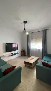 a living room with two couches and a tv at La perle de Benicarló 1 in Benicarló