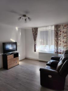 a living room with a couch and a television at Gara De Nord 3 Rooms Apartment Superb City View in Bucharest