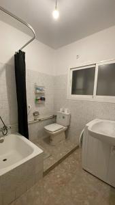 a bathroom with a sink and a toilet and a tub at La perle de Benicarló 1 in Benicarló