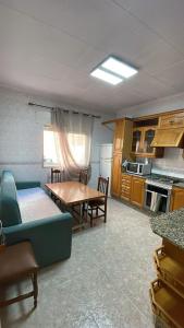 a kitchen with a couch and a table in a kitchen at La perle de Benicarló 1 in Benicarló