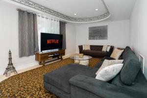 a living room with a couch and a television at Frybrook in Richmond Hill