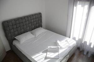 a white chair sitting on a bed in a bedroom at Le Fabuleux Mazagran in Mostaganem