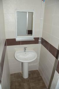 a bathroom with a sink and a mirror at Le Fabuleux Mazagran in Mostaganem +29 photos