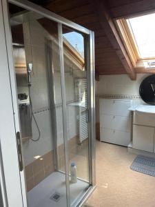 a glass shower in a bathroom with a sink at Mia Experience Lake Como in San Fermo della Battaglia +83 photos