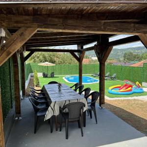 a patio with a table and chairs and a playground at Holiday home Mumi in SJJ