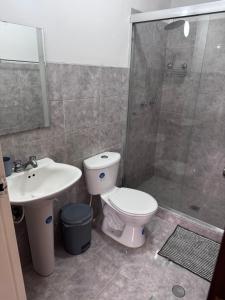 a bathroom with a toilet and a sink and a shower at Apartamento zona Hesperia Sambil Complejos Deportivos in Naguanagua +2 photos