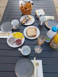 a picnic table with plates of food on it at Disneyland Paris dream 2 rooms & breakfast in Magny-le-Hongre +5 photos