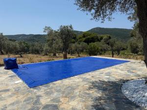 a blue tarp on top of a stone patio at Villa Afroditi, Skiathos, Kalivia, Greece in Skiathos National Airport +22 photos