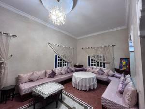 a living room with a couch and a table at Charming villa in Safi in Safi