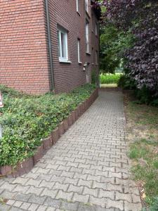 a brick walkway in front of a brick building at Red Dot Apartment Otto in Hamm