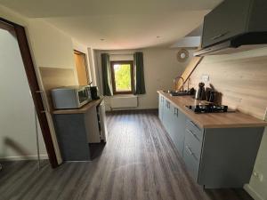 a kitchen with a counter and a microwave in it at Le magnolia in Épieds +14 photos